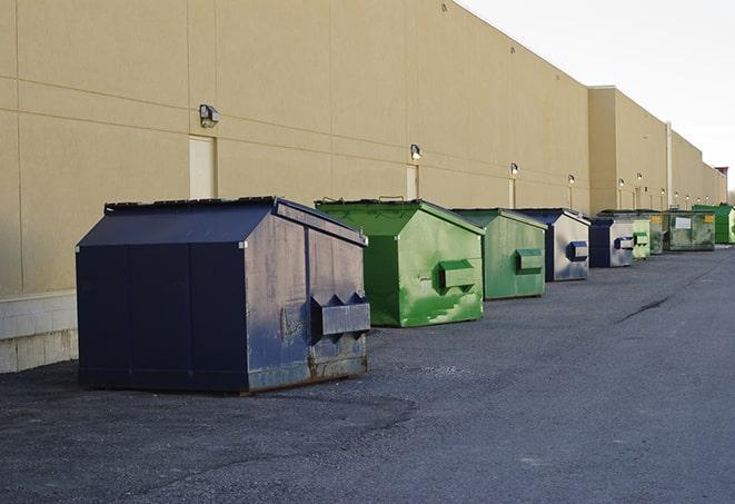 a yellow construction dumpster filled with waste materials in Bement